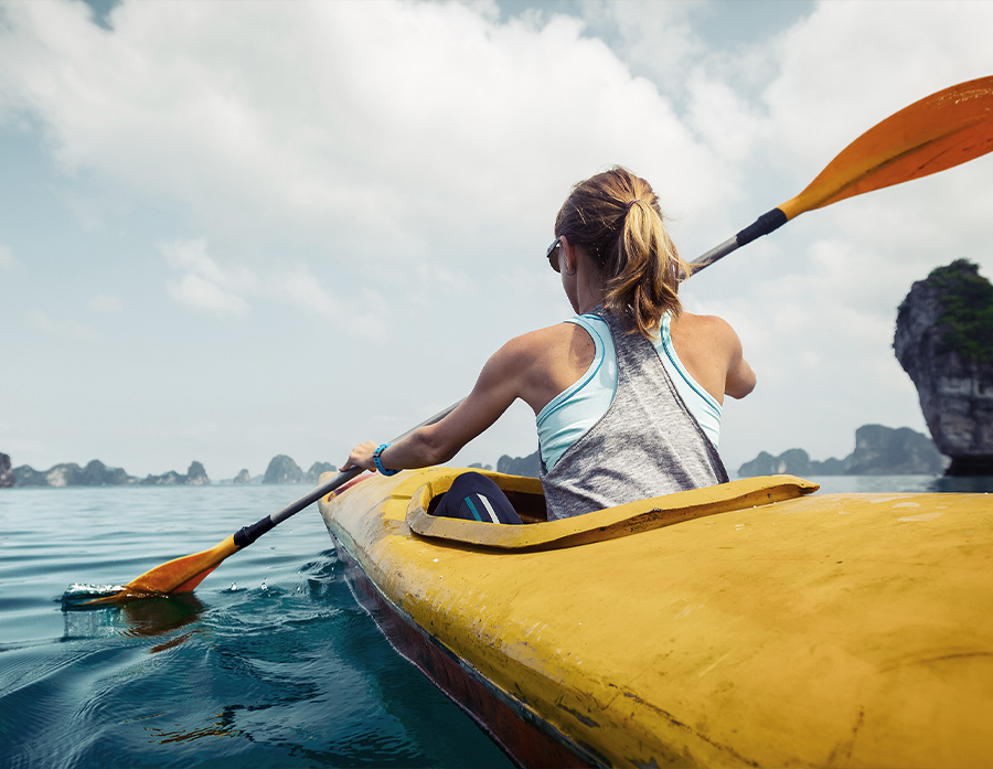 Melbourne wealth creation concept - Young woman paddling kayak